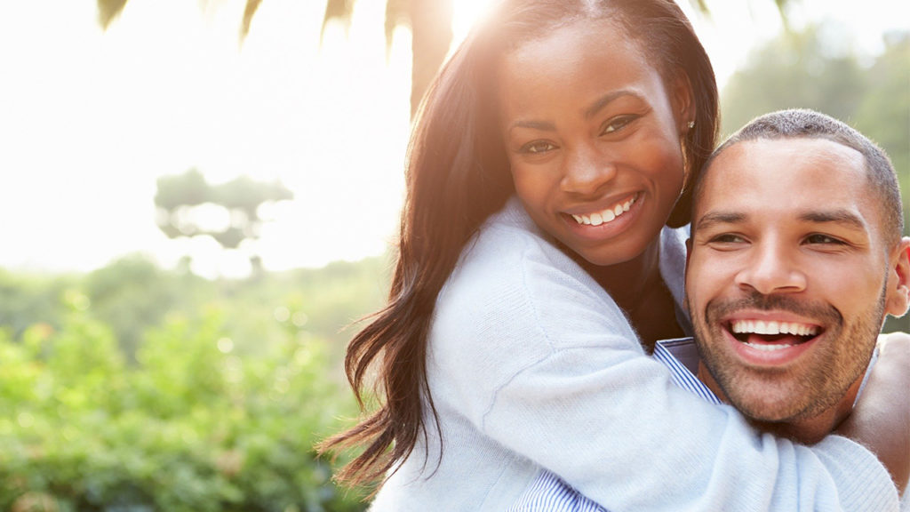 Couple smiling and having fun outside