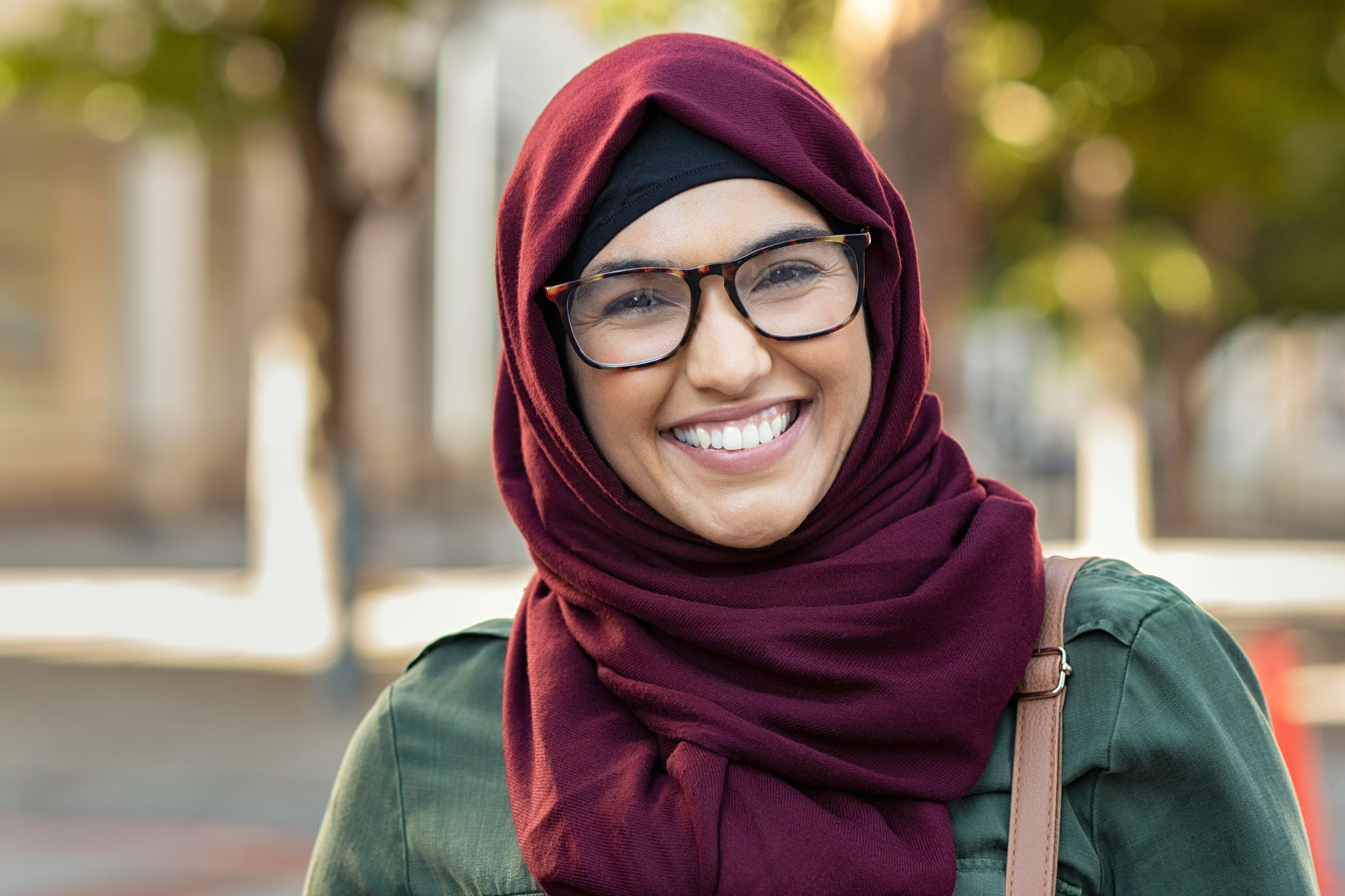 Smiling young woman with glasses in hijab