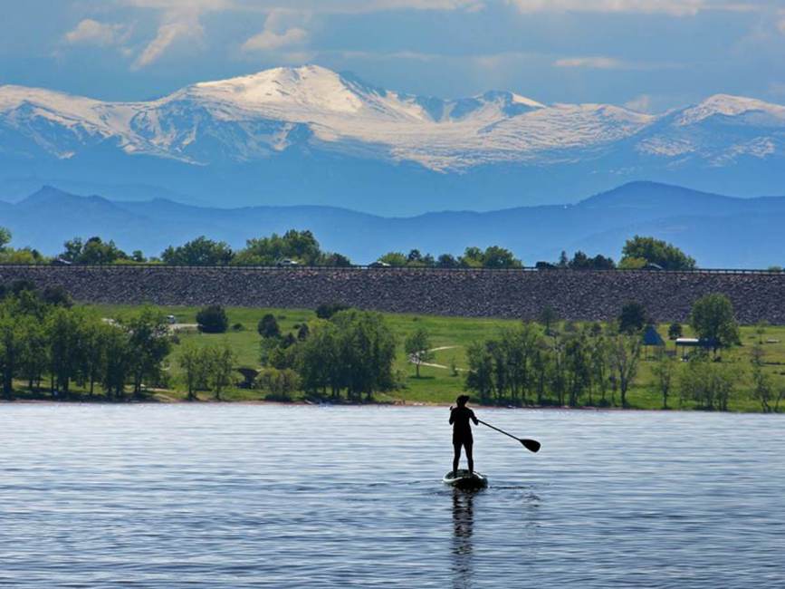 Paddle boarder on late at cherry creek state park in Aurora CO
